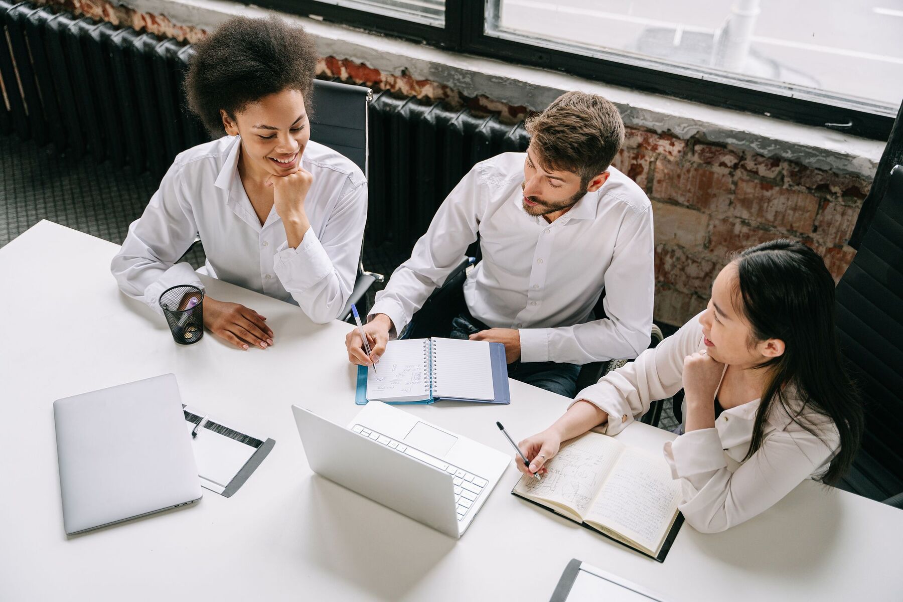 Business professionals reviewing freight plans together in a meeting room